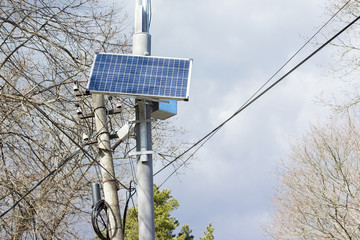 solar panels in an electric column alternative energy from the sun. It is used for regulating traffic lights, lighting lampposts, and power supply. Earth day and ecology concept