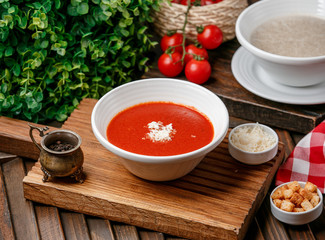 tomato soup with cheese on wooden board