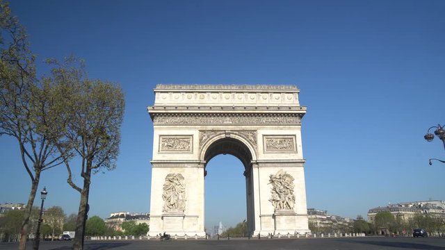 Paris street with the Arc de Triomphe in Paris, France.