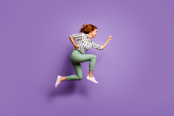 Full length profile side photo of funny cheerful woman jump run hurry copy space after discount wear good look outfit isolated over violet color background