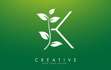 White Leaf Letter K Logo Design with Leaves on a Branch and Green Background. Letter K with nature concept.
