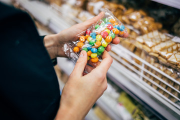Female hands holding package of candies