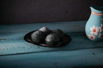 sweet green muffins with a turquoise vase photographed on a wooden background