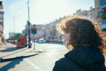 Portrait young woman wearing medical face mask walking