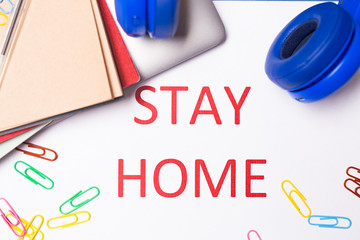Desk top with Words stay at home. Coronavirus Pandemic Protection Concept. Stay safe, concept of self quarantine at home as preventative measure against virus outbreak. Social Distancing wording.