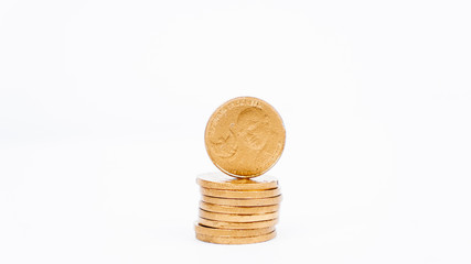 Golden coins stacked on white background