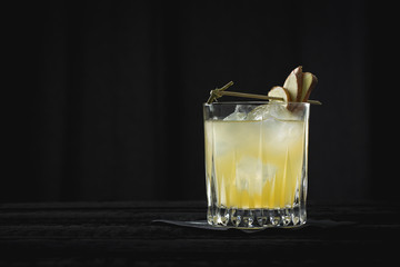 vintage style whisky sour, orange cocktail on the black background