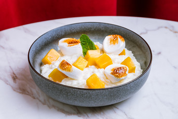 rice porridge with mango and marshmallows
