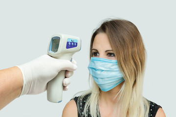 measurement of woman's temperature by infrared non-contact thermometer