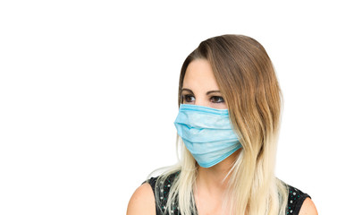 Woman wearing blue medical mask looks left