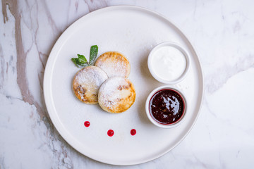 cheesecakes from cottage cheese on white plate