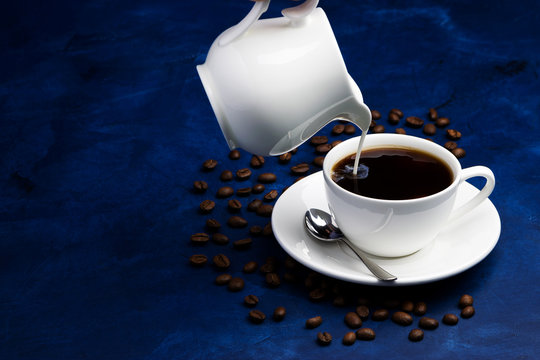 Black Coffee With Milk On A Deep Blue Background