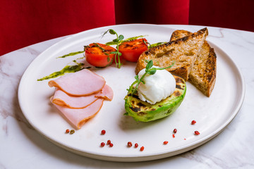 eggs Benedict with bacon and avocado