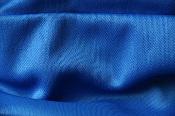 fondo azul textil con reflejos de luz blanca
