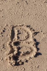 the letter b written on beach sand
