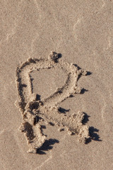 the letter r written in beach sand
