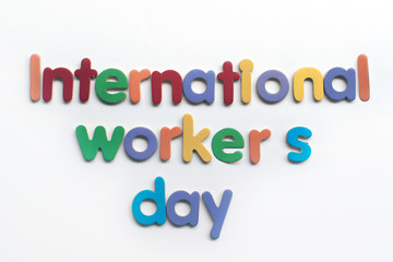 International workers' day text in multi color on white background with construction repair tools. Labor day concept sign. International workers' day text written on white background.