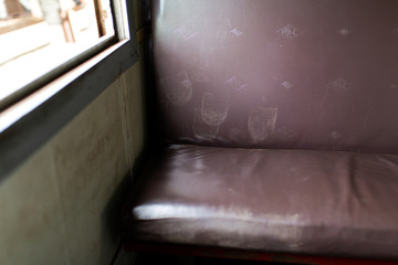 Interior of a passenger train carriage in Sri Lanka. Seat with dirty footprints on it
