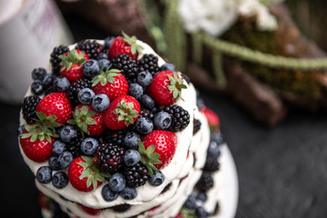 the cake is decorated with berries strawberries, blueberries, blackberries