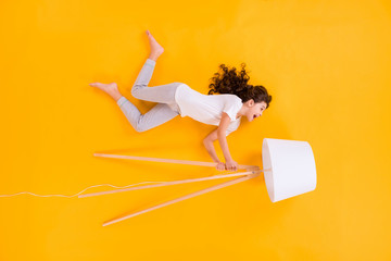 Full body high angle above flat lay view photo of beautiful crazy funny little lady lying hold...