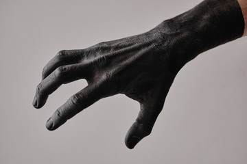 Male hands, painted in black, shows gestures and movement.