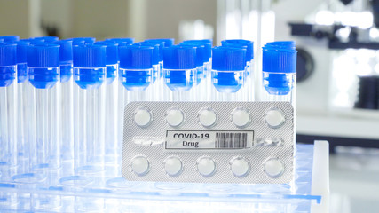 Blue cap empty test tubes with the coronavirus pills