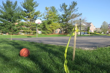 Closed Basketball Courts Due to Covid-19 with Basketball Nearby