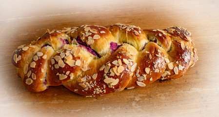 Easter sweet bread with almonds on wooden table
