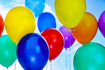 Many colorful balloons outdoors on sunny day, closeup