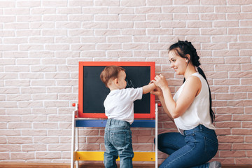 The child at the blackboard, studying at home, education during quarantine, how to learn during isolation