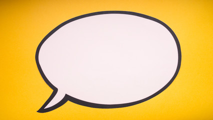 paper speech bubble on yellow background