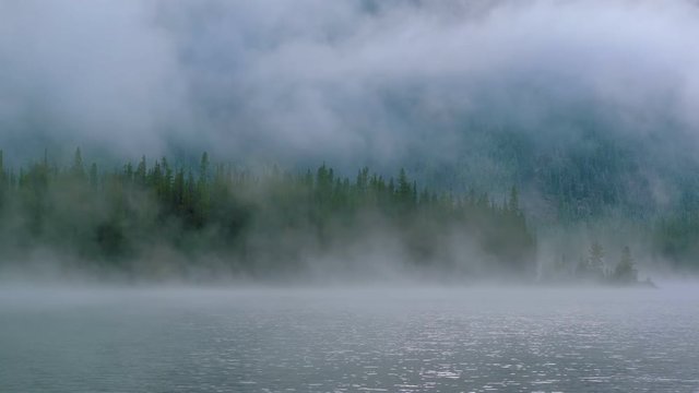 Central Cascades, Washington - Thick Fog Over The Peaceful Lake Covering The Lush Pine Trees - Wide Shot