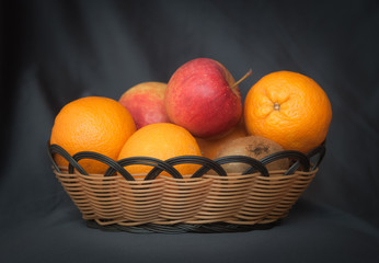 basket with oranges, apples, kiwi