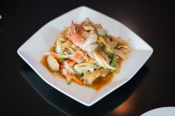 Thai papaya salad with fresh shrimp and crispy pork skin, a popular food for Thai people