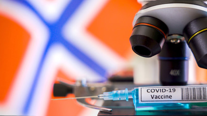 Fototapeta na wymiar A Norway flag on the back waving with the Covid-19 vaccine for coronavirus