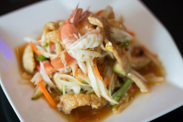 Thai papaya salad with fresh shrimp and crispy pork skin, a popular food for Thai people