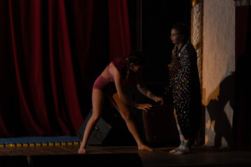 Girls show the performance on stage in the theater.