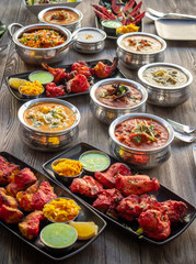 various Indian dishes on wooden table