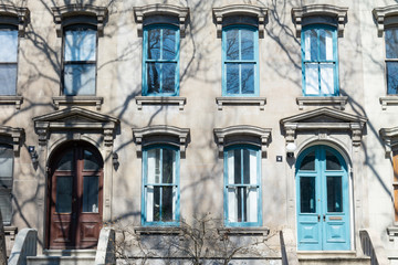 Fototapeta na wymiar Facades of Fancy Old Stone Homes with Colorful Doors in Long Island City Queens New York