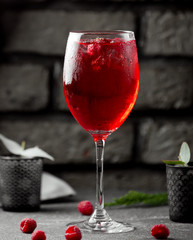 a glass of cold raspberry drink