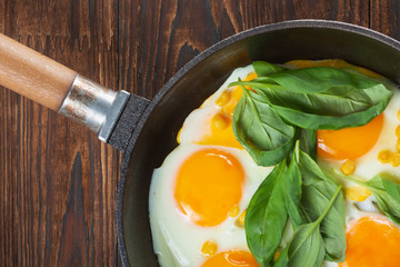 Fried eggs for breakfast close-up. Wooden table. Healthy eating