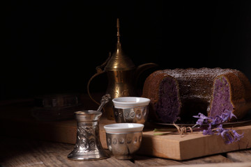 sweet purple  bundt cake with coffee cups as a symbol for Islam