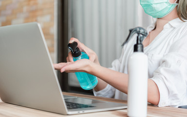 Coronavirus. Business woman working from home wearing protective mask. Business woman in quarantine for coronavirus wearing protective mask.