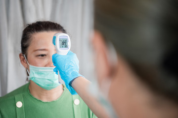 Measure women fever with digital fever meter. sick girl with high feve
