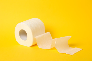 Toilet paper on yellow background, space for text