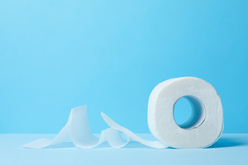 Toilet paper on blue background, space for text