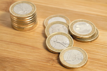 Euro coin column on a wooden table and a white background with on white background with copy space for your text. Money, Financial, Business Growth concept.