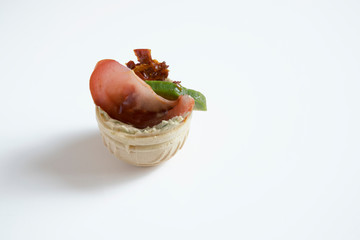  Tartlet stuffed with vegetables on a white background.