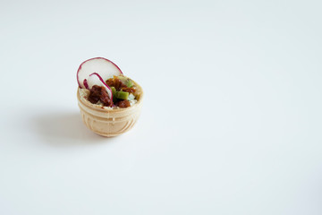 One tartlet cooked at home on a white background.