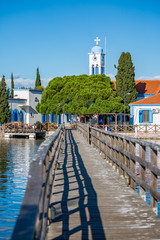 Fototapeta premium The beautiful monastery of St. Nicholas built on Lake Vistonida, Porto Lagos, Xanthi region in Northern Greece, view with the water bridge